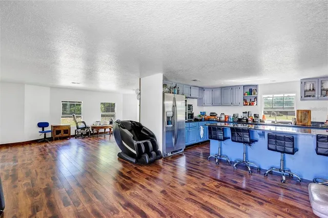 a living room with furniture and kitchen view
