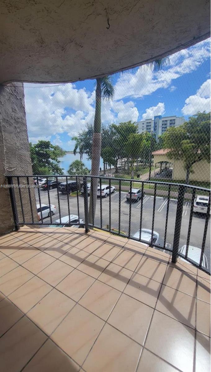 5199 Northwest 7th Street, Unit 309 Miami, FL 33126 - Photo 4 of 4 a view of a balcony with furniture and city view
