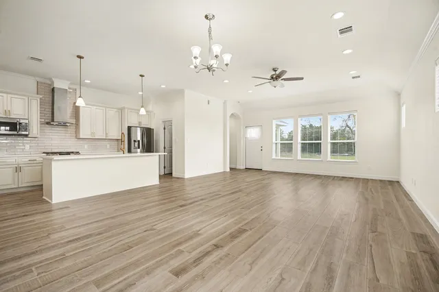 a view of a kitchen with wooden floor and a kitchen