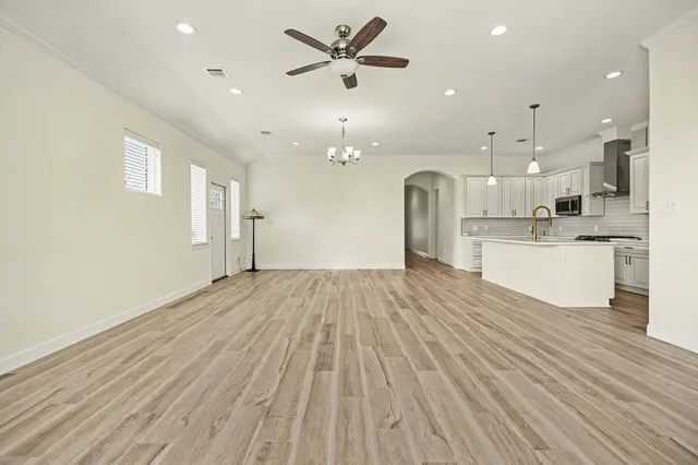 a view of a kitchen with a sink and a refrigerator