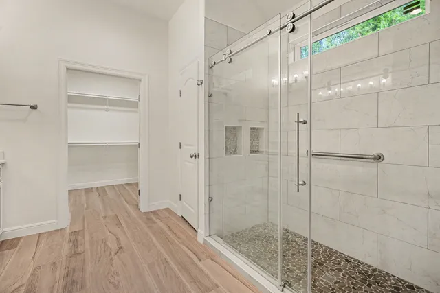 a bathroom with a glass shower door