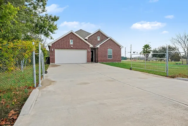 a front view of a house with a yard and trees