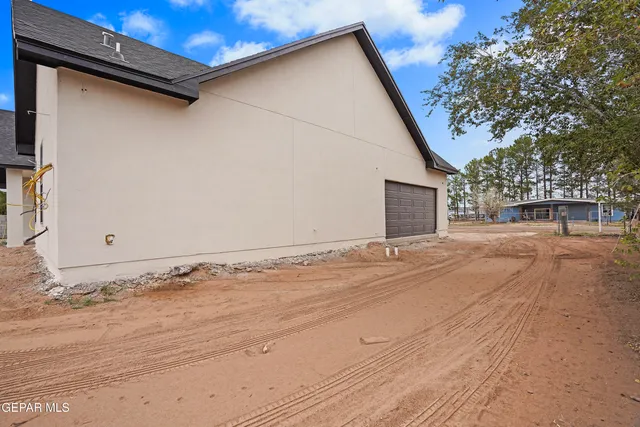 a view of garage yard and tree