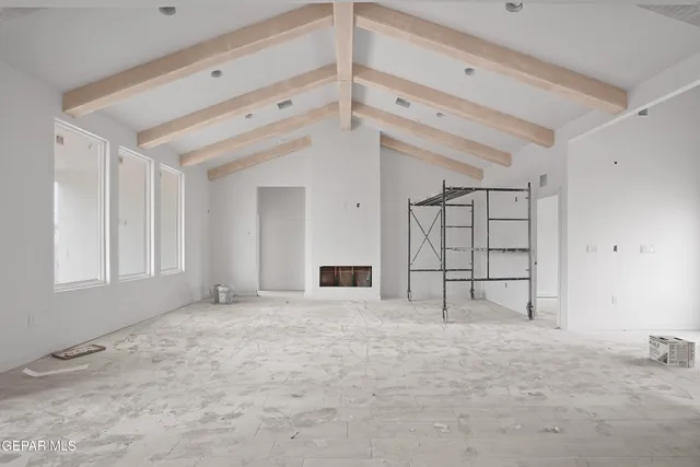 a view of empty room with cabinet and window