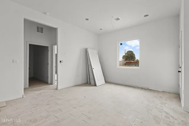 a view of an empty room with a window