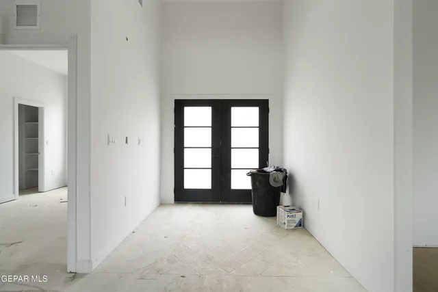 an empty room with windows and closet