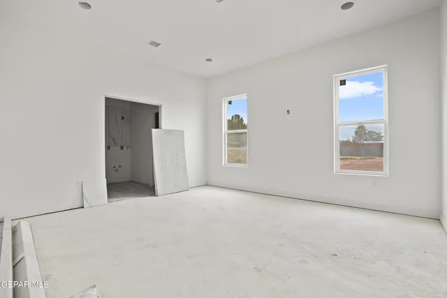 an empty room with windows and closet