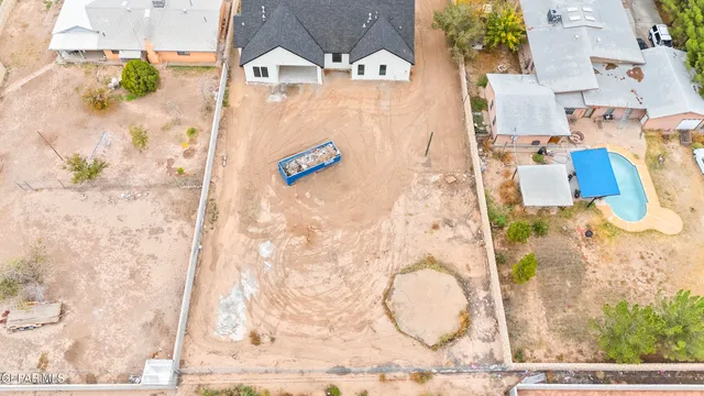 an aerial view of a house with a backyard