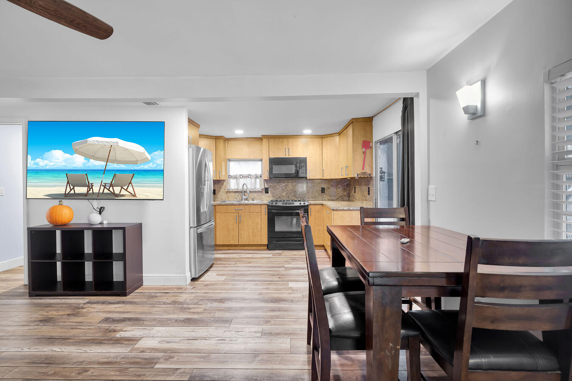 7 Avenue D Key Largo, FL 33037 - Photo 18 of 36 a kitchen with a table chairs refrigerator and cabinets