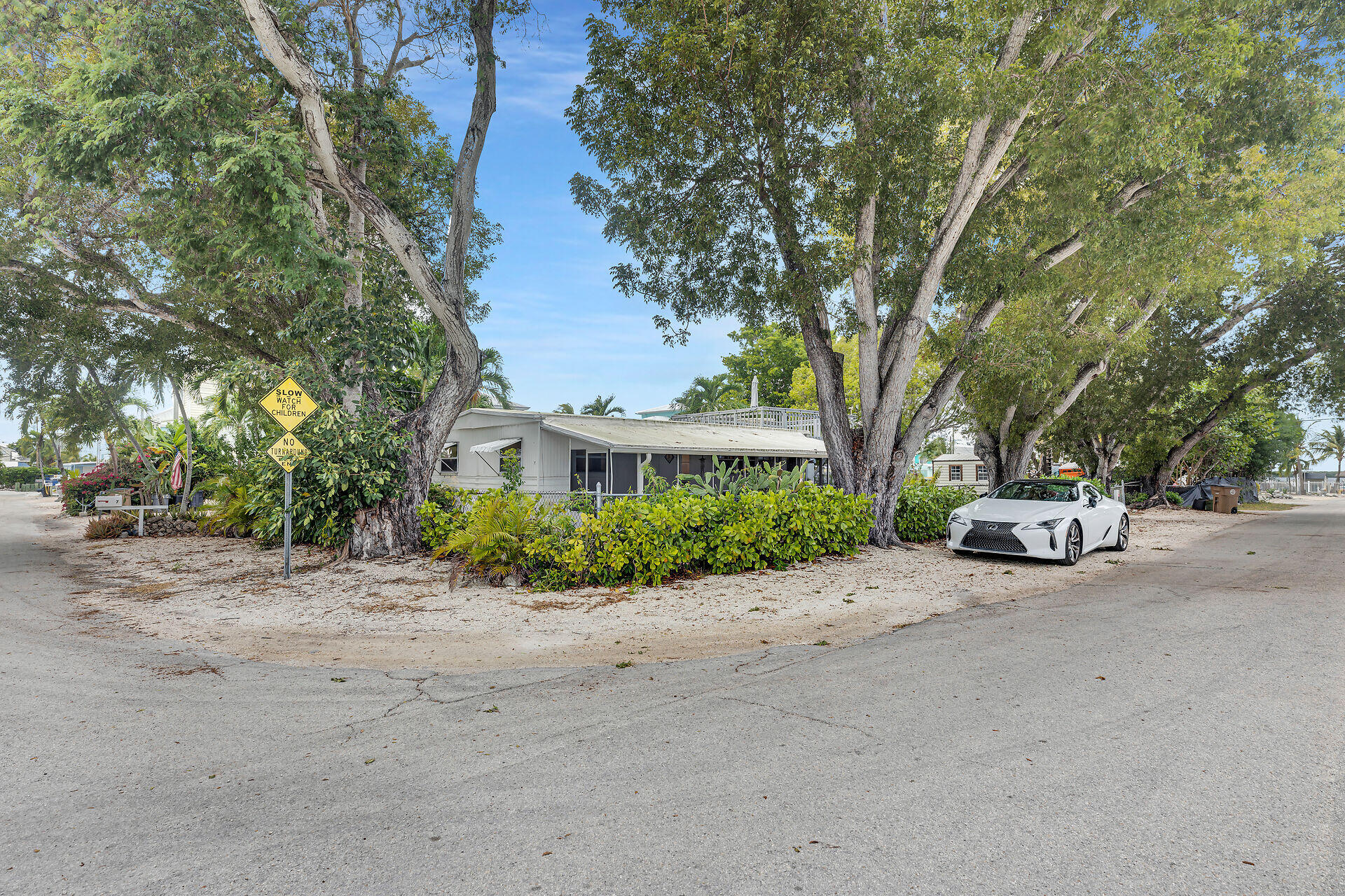 7 Avenue D Key Largo, FL 33037 - Photo 31 of 36 a view of a street with a building and trees in the background