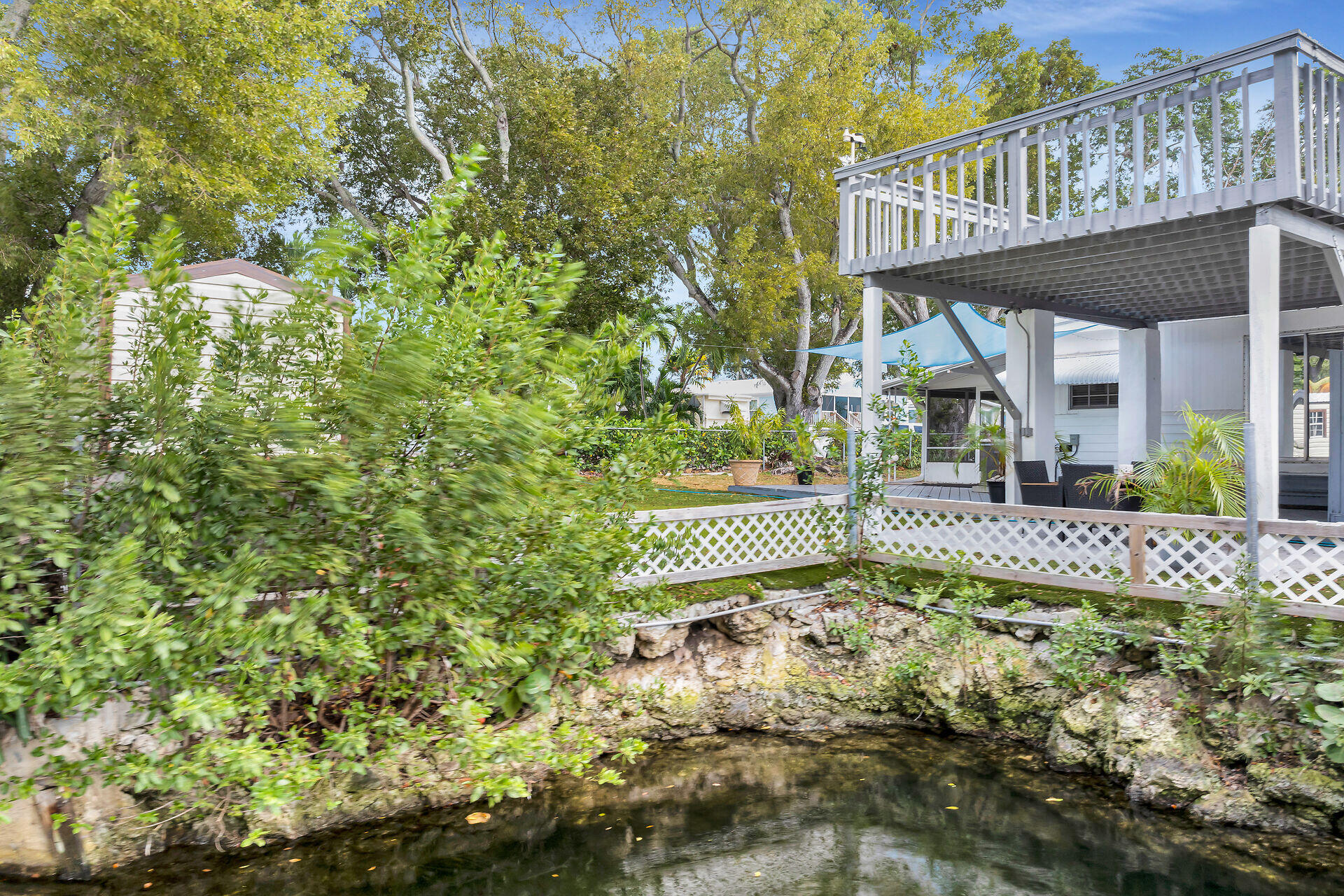 7 Avenue D Key Largo, FL 33037 - Photo 33 of 36 a view of a house with a small yard and wooden fence