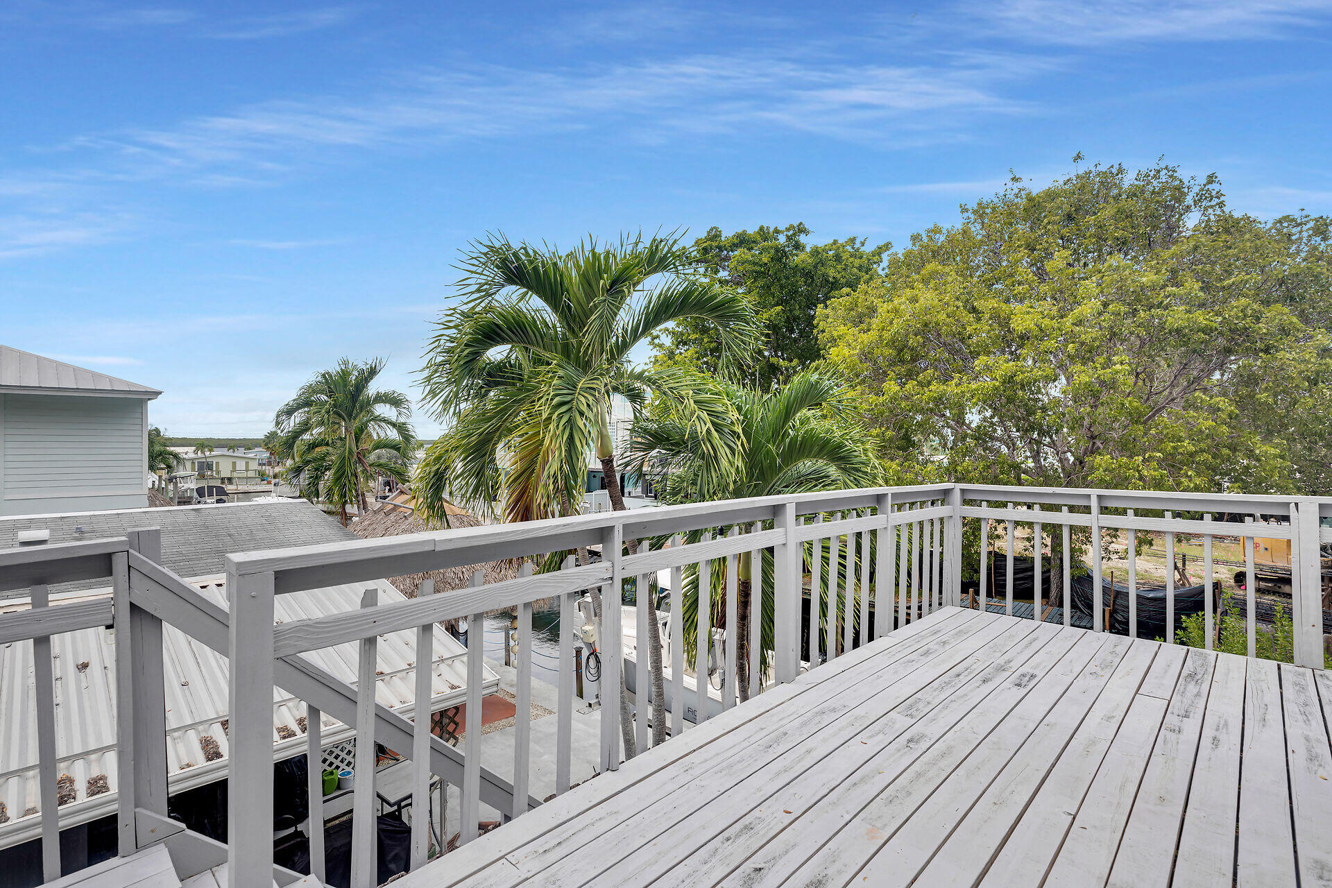 7 Avenue D Key Largo, FL 33037 - Photo 4 of 36 a view of a balcony with wooden floor and fence