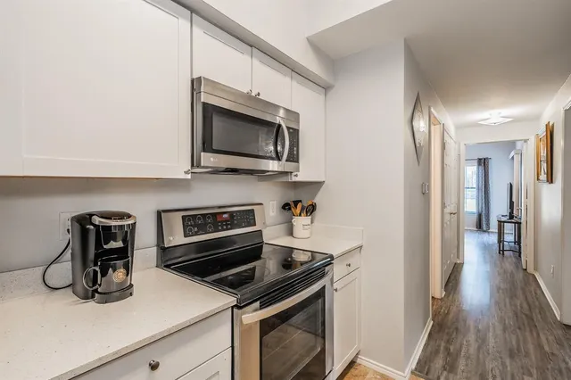a kitchen with a stove and a microwave