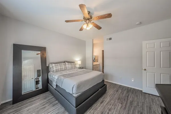 a bedroom with a bed and a ceiling fan
