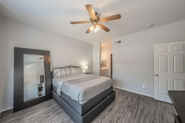 a bedroom with a bed and a ceiling fan