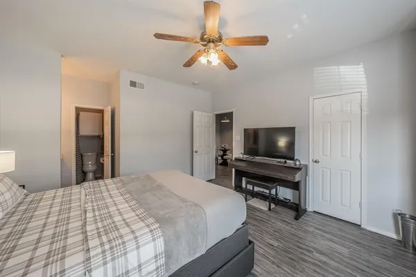 a bedroom with a bed and a flat screen tv