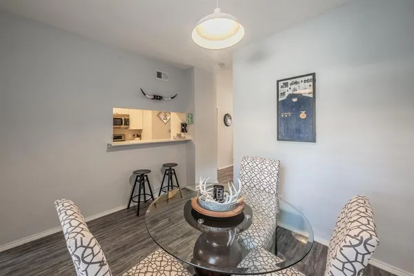 a dining room with furniture and wooden floor
