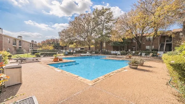 a swimming pool with outdoor seating and yard