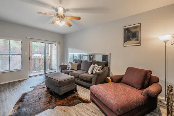 a living room with furniture ceiling fan and a window