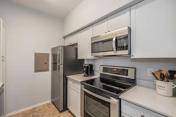 a kitchen with a refrigerator stove and microwave