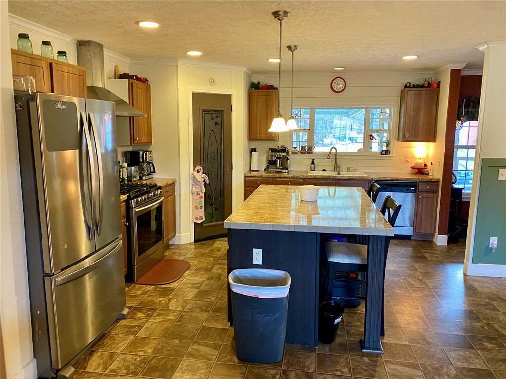 597 Sam Byrum Road Iva, SC 29655 - Photo 13 of 43 This spacious kitchen offers ample room for culinary endeavors and gatherings.