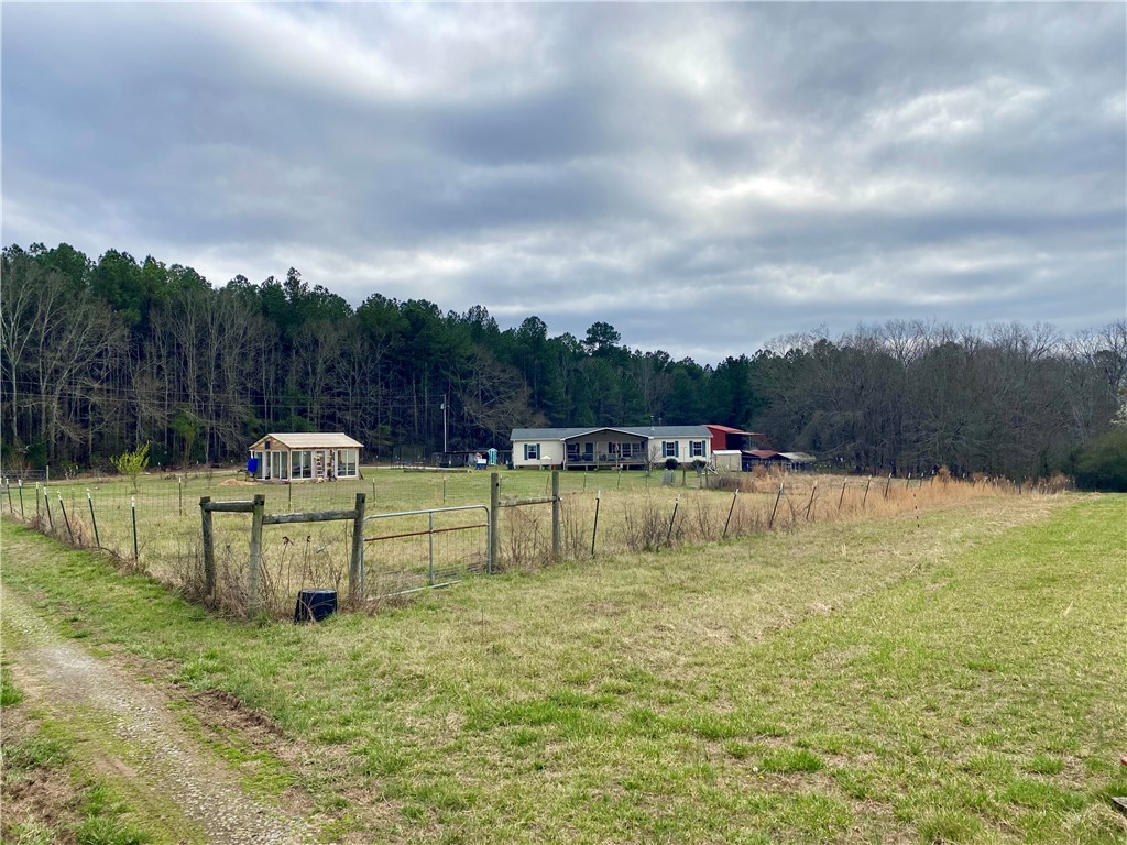 597 Sam Byrum Road Iva, SC 29655 - Photo 2 of 43 Expansive green fields offer abundant space for outdoor living and recreation.