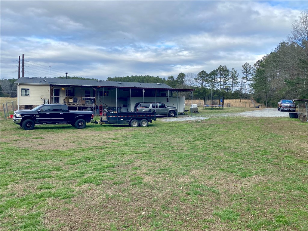 597 Sam Byrum Road Iva, SC 29655 - Photo 31 of 43 This expansive rural property features a well-maintained home with ample outdoor space.