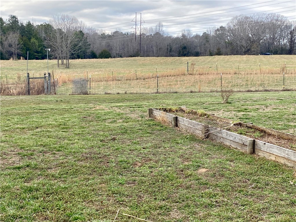 597 Sam Byrum Road Iva, SC 29655 - Photo 40 of 43 Expansive outdoor space offering verdant fields and a rustic garden bed.