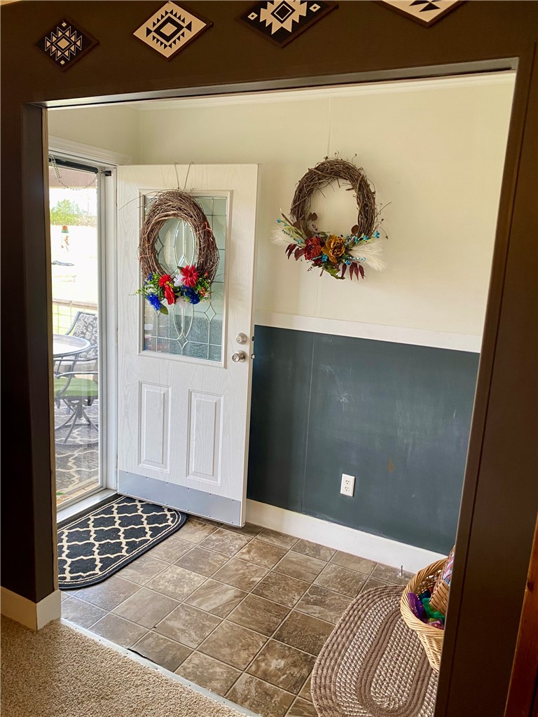 597 Sam Byrum Road Iva, SC 29655 - Photo 4 of 43 The entryway features a classic door with decorative glass, setting a welcoming tone.