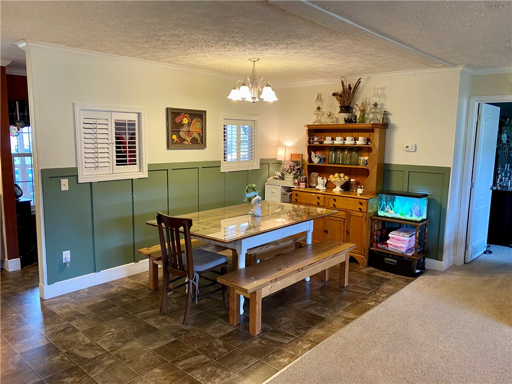 597 Sam Byrum Road Iva, SC 29655 - Photo 8 of 43 This inviting dining area features elegant wainscoting and durable tile flooring, perfect for everyday meals.