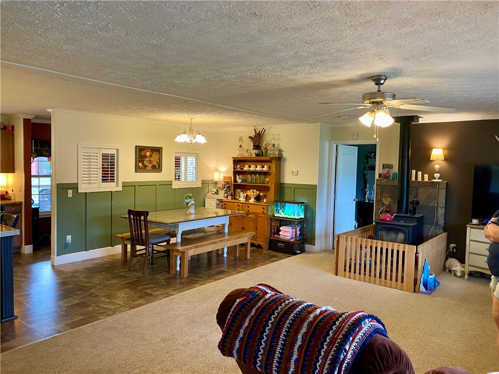 597 Sam Byrum Road Iva, SC 29655 - Photo 9 of 43 This inviting space combines a cozy dining area with a comfortable living room, featuring practical and warm elements.