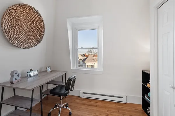 a view of a room that has a table and chair in it