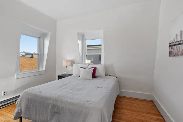 a bedroom with a bed and window