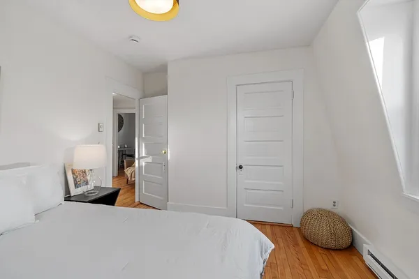 a bedroom with a bed and a chair