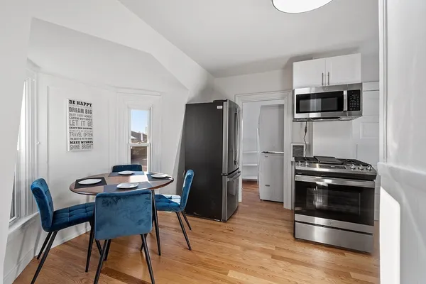 a kitchen with stainless steel appliances a stove a microwave and a refrigerator