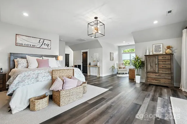 a bedroom with furniture and wooden floor