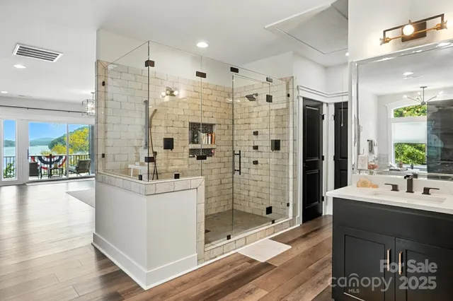 a large white kitchen with a double vanity sink and a large mirror