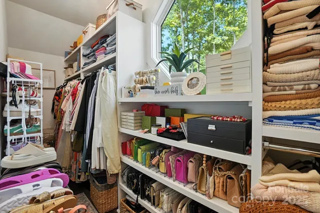 a living room with lots of furniture and a book shelf