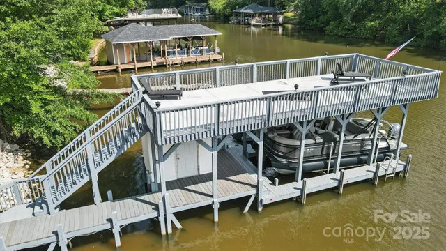 a view of roof deck with plants and lake view