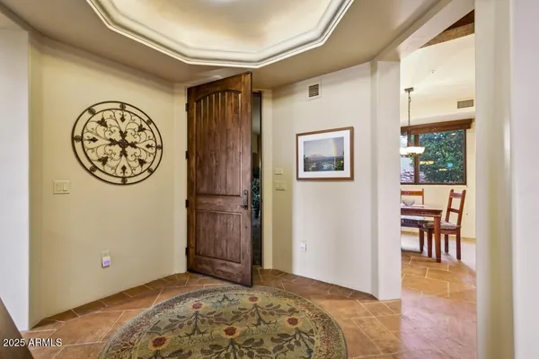 a living room with furniture and a floor to ceiling window