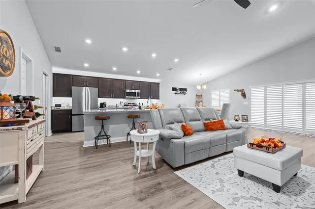 a living room with lots of furniture and kitchen view