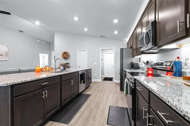 a room with toys and a kitchen view