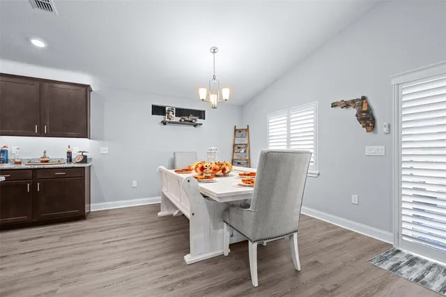 a view of a dining room with furniture and wooden floor