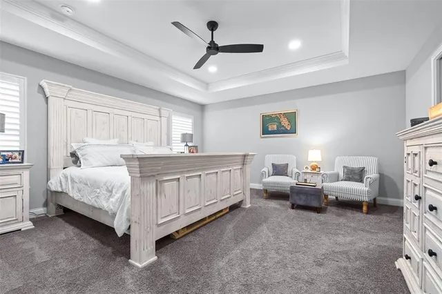 a spacious bedroom with a bed and a flat screen tv