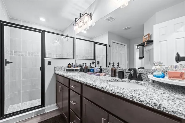 a bedroom with a bed and a night stand