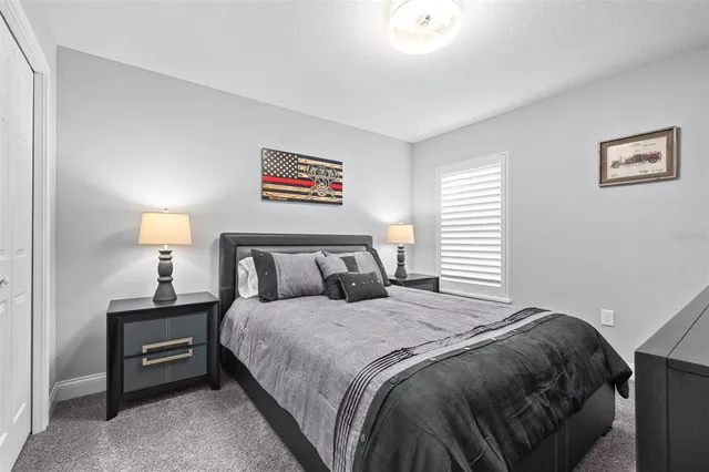 a bedroom with a bed and a painting on the wall