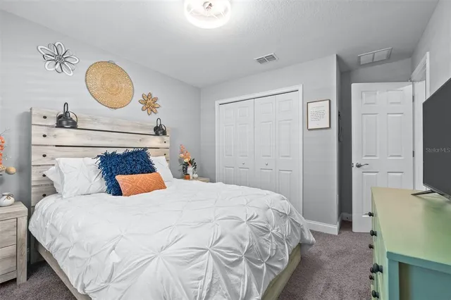 a living room with a couch a rug and a large window