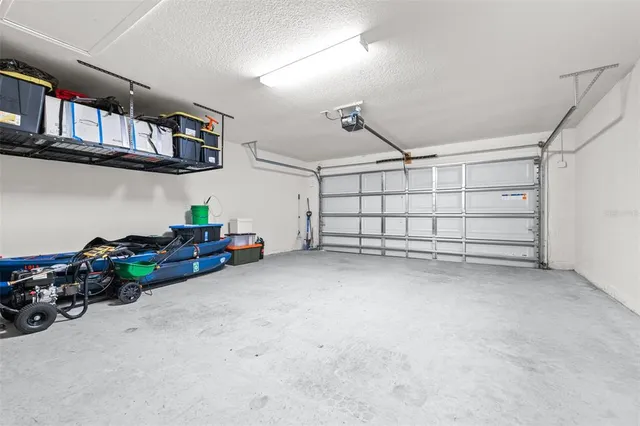 a living room with couch floor to ceiling window and a flat screen tv