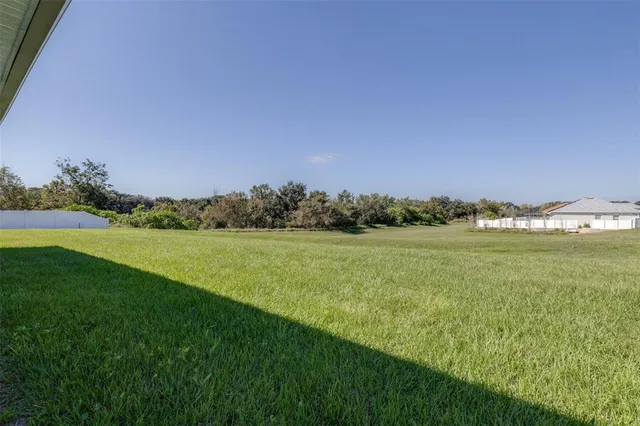 a view of a house with a yard and sitting area