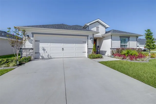 a front view of a house with a yard and garage